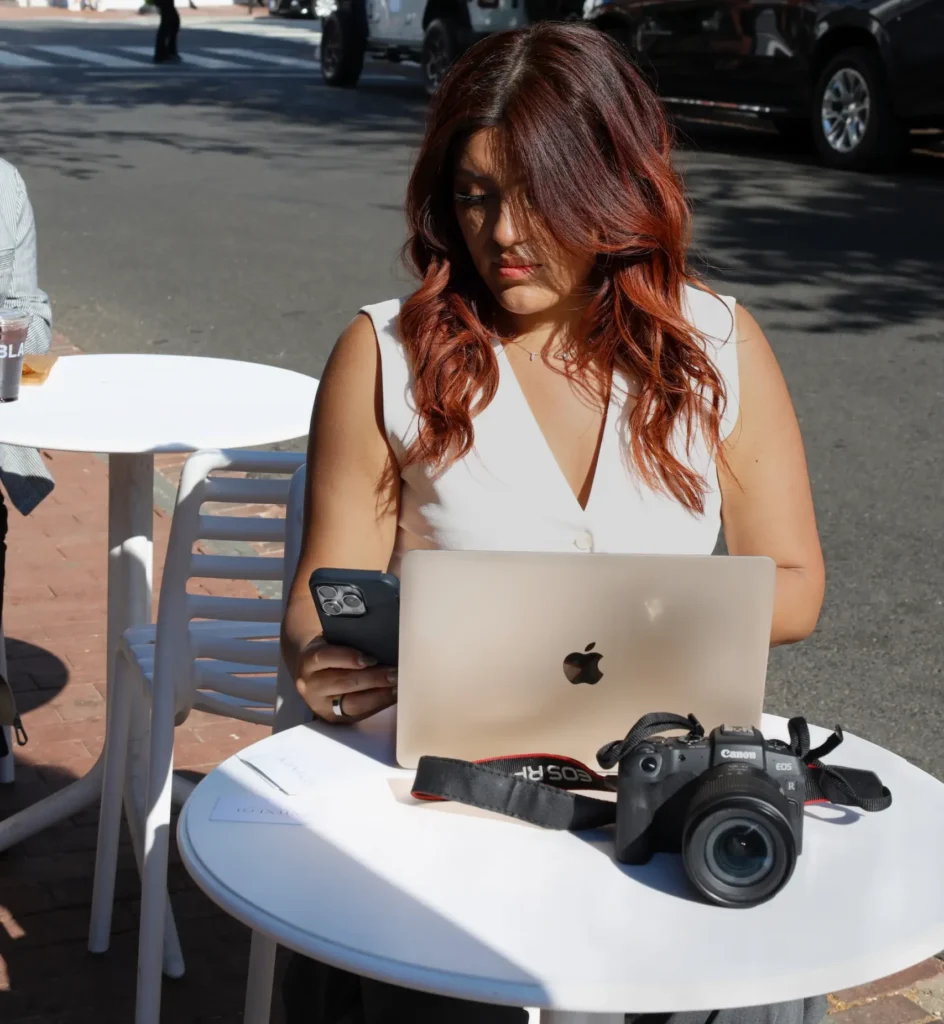 Woman working on laptop at outdoor cafe