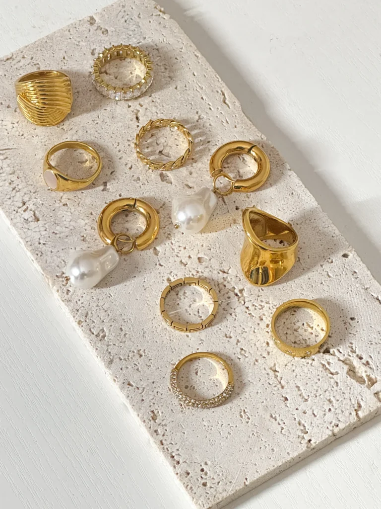 Collection of gold rings on textured surface